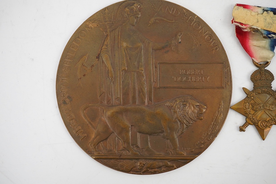 A First World War medal trio and commemorative plaque awarded to PTE. R. Docherty S. GDS. Condition fair.